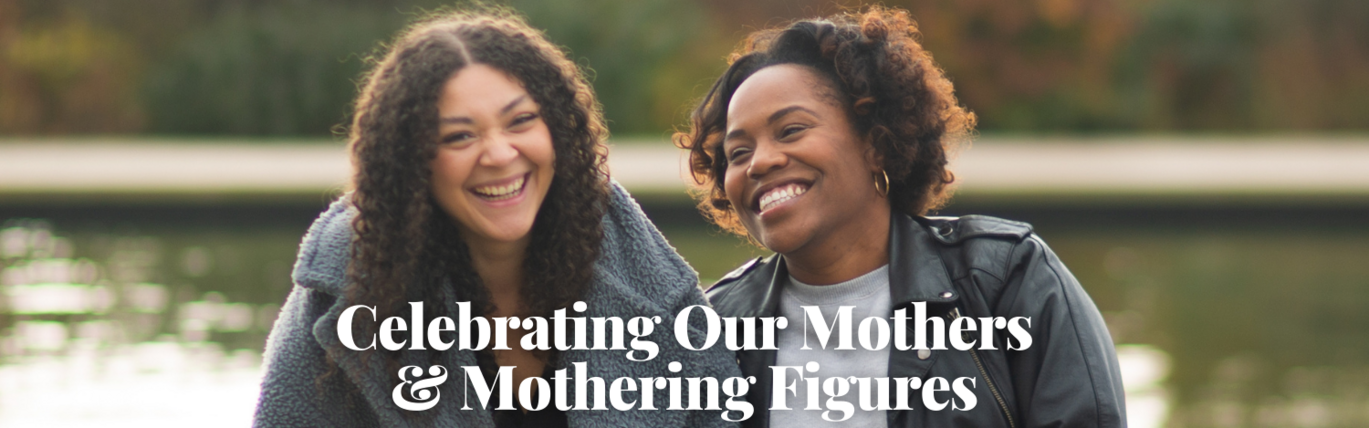 Two mothers side by side laughing