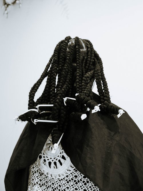 Woman with box braids from behind.