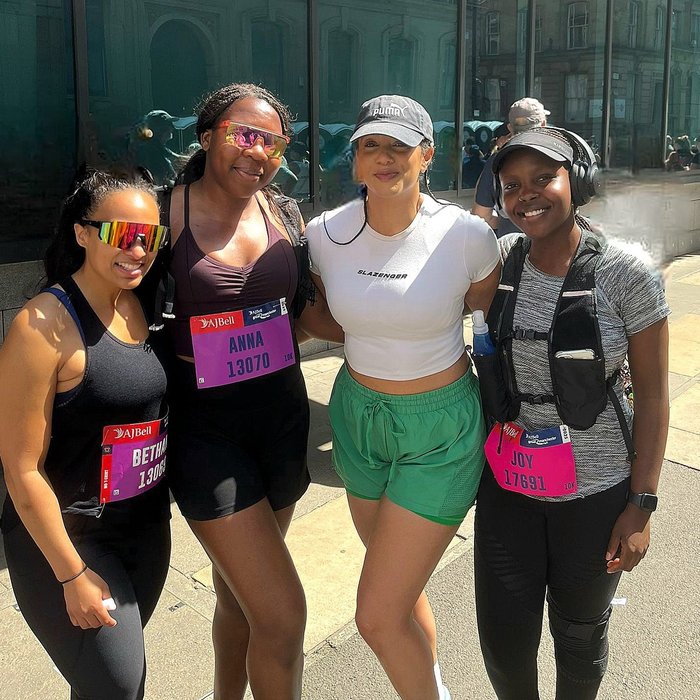 Group of black women posing after a marathon.