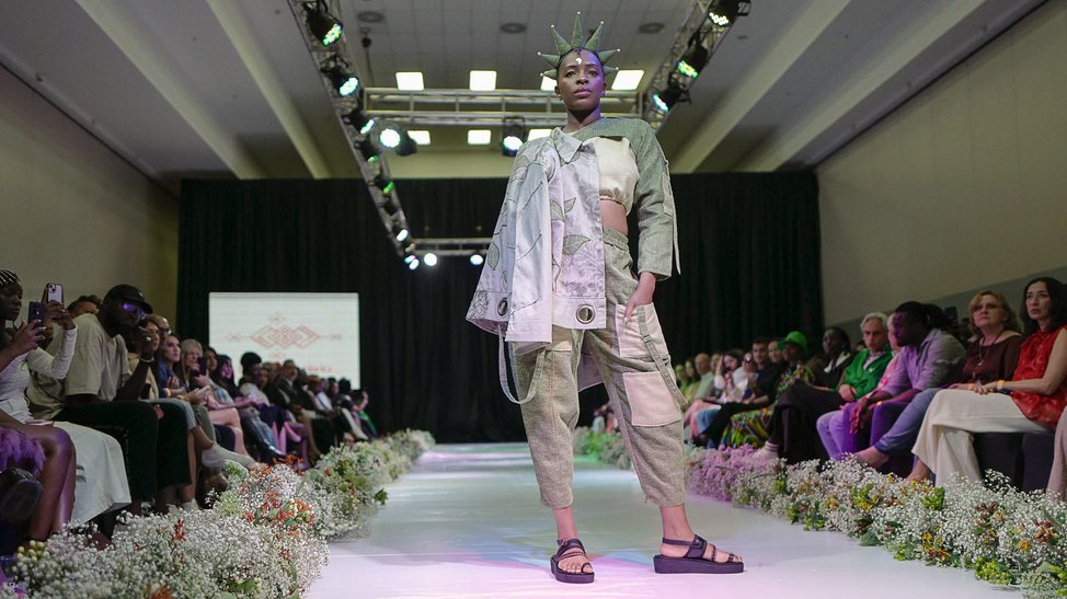 Black model wearing a co-ordinated khaki and cream tactical top and trousers.