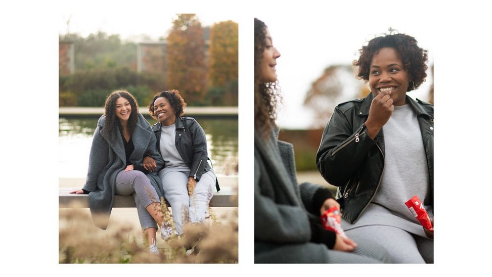 Diptych of Monique and Yemisi sitting next to each other near a lake, laughing and sharing Maltesers.