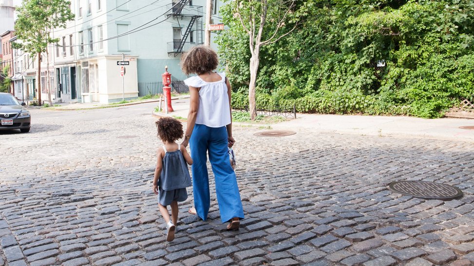 Mother and child walking hand in hand down the street © Sai De Silva